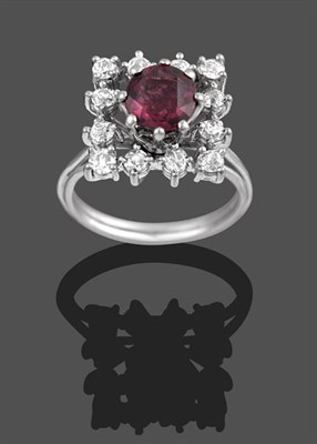 Lot 2112 - A Garnet and Diamond Cluster Ring, the round cut oval garnet within a border of round brilliant cut