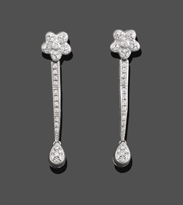 Lot 2114 - A Pair of Diamond Drop Earrings, a floral motif suspends three articulated links to a pear...