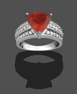 Lot 2117 - A Fire Opal and Diamond Ring, the trilliant cut fire opal to triple row round brilliant cut diamond