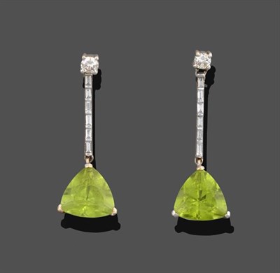 Lot 2118 - A Pair of Peridot and Diamond Drop Earrings, a round brilliant cut diamond suspends a fixed bar...