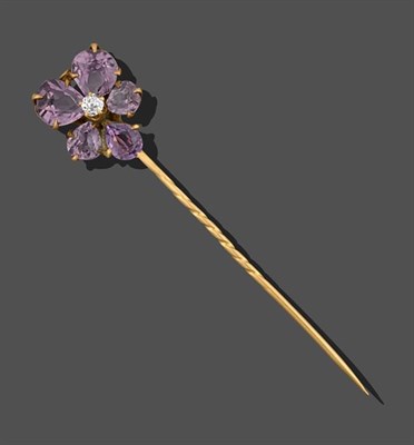 Lot 2121 - A Flower Head Amethyst and Diamond Stick Pin, the stylised flower head formed of an old cut diamond