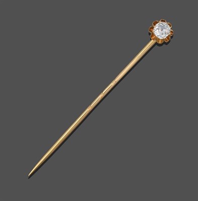 Lot 2122 - A Diamond Stick Pin, an old cut diamond in a yellow claw setting to a scroll border, estimated...