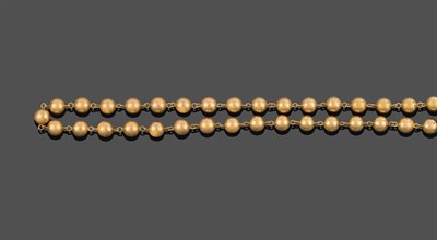 Lot 2123 - A Bead Necklace, thirty-five spherical yellow metal beads with chain links between, length...