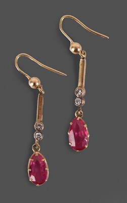Lot 2130 - A Pair of Synthetic Ruby and Diamond Drop Earrings, a yellow bead suspends a tapered bar...