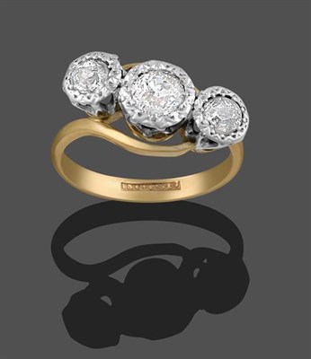 Lot 2132 - A Diamond Three Stone Twist Ring, the old cut diamonds in white millegrain settings, on a...