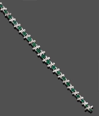 Lot 2147 - An Emerald and Diamond Bracelet, graduated round cut emeralds alternate with four round...
