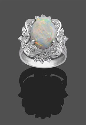 Lot 2151 - An Opal and Diamond Cluster Ring, the oval cabochon opal in a white four claw setting, within a...