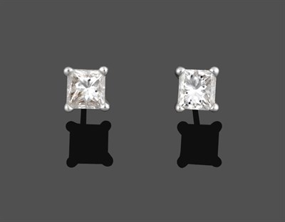 Lot 2154 - A Pair of Diamond Solitaire Earrings, the princess cut diamonds in white four claw settings,...