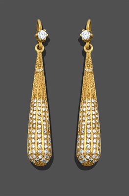 Lot 2160 - A Pair of Diamond Drop Earrings, a round brilliant cut diamond in a yellow claw setting...