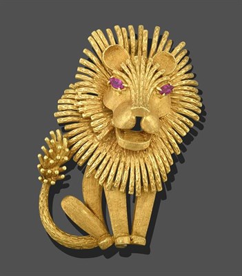Lot 2166 - A Lion Brooch, realistically modelled as a seated lion, with ruby set eyes in yellow claw...