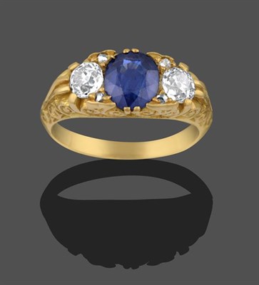 Lot 2174 - A Sapphire and Diamond Three Stone Ring, an oval cut sapphire sits between two old cut...