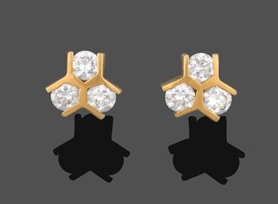 Lot 2185 - A Pair of 18 Carat Gold Diamond Cluster Earrings, trios of round brilliant cut diamonds spaced...