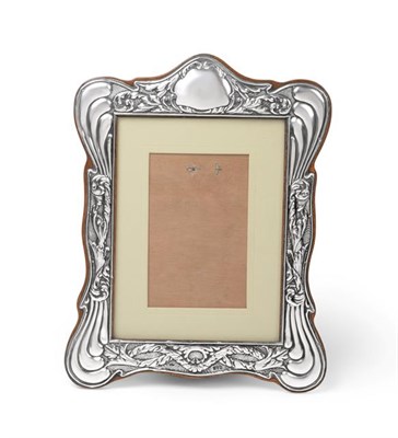 Lot 2424 - An Edward VII Silver Photograph-Frame, Maker's Mark Indistinct, Chester, 1908, shaped oblong,...