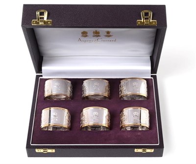 Lot 2445 - A Set of Six Elizabeth II Parcel-Gilt Silver Napkin-Rings, by Asprey, London, 2002, Britannia...