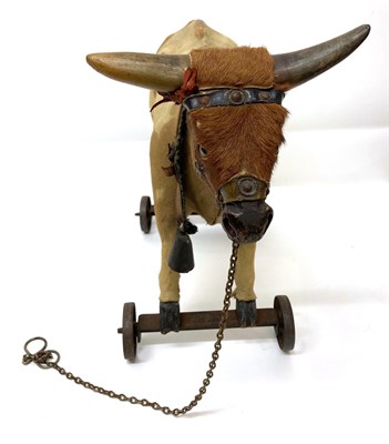 Lot 2001 - Late 19th Century Pull Along Cow, possibly German, with hide covered body, real horns, glass...