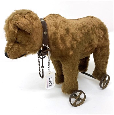 Lot 2002 - An Early 20th Century Steiff Pull Along Bear on Wheels, with jointed head, boot button eyes,...
