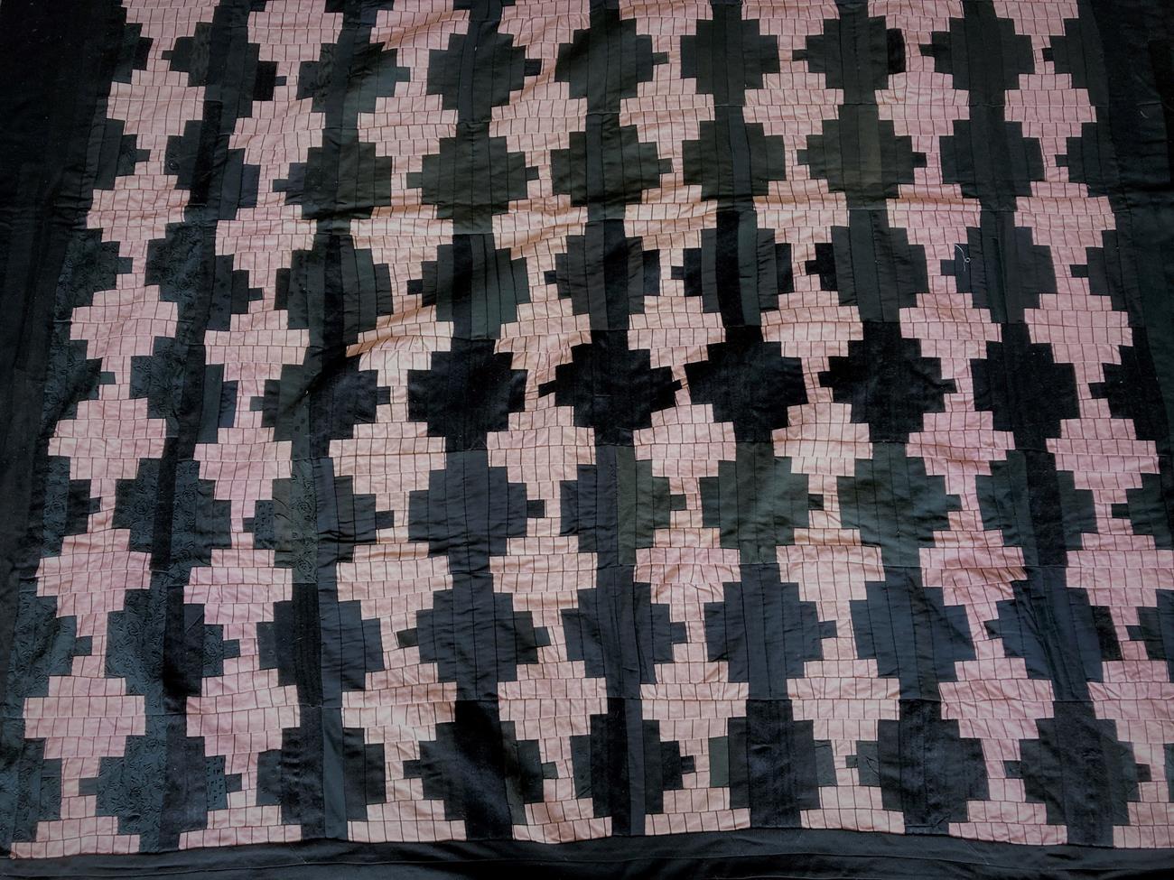 Lot 2008 - Late 19th/Early 20th Century Patchwork Quilt, incorporating pink and black patchwork motifs on...
