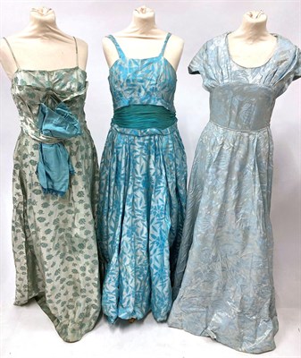 Lot 2054 - Circa 1950s Ladies' Evening Dresses, comprising Sambo Fashions pale blue brocade dress with...