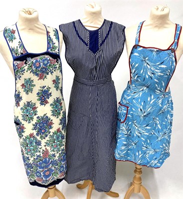 Lot 2056 - Assorted Circa 1950s/1960s Aprons and House Coats, in decorative printed cottons on tabards,...