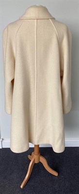 Lot 2065 - A Burberrys Lady's Cream Wool Knee-Length Coat, 1980s/1990s, with concealed button fastening...