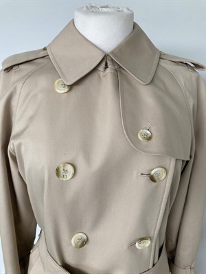 Lot 2075 - A Burberrys Lady's Stone Coloured Double Breasted Belted Trench Coat, 1980s/1990s, with slit...