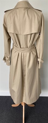 Lot 2075 - A Burberrys Lady's Stone Coloured Double Breasted Belted Trench Coat, 1980s/1990s, with slit...