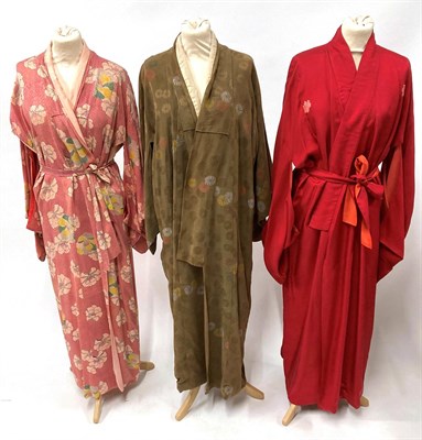 Lot 2079 - 20th Century Robes and Kimonos, including a black full length long sleeved house coat decorated...
