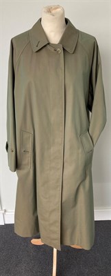 Lot 2081 - A Burberrys Ladies' Olive Green Fly-Front Coat, Mid 1990s, with check lining and slit pockets...