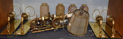 Lot 14 - ^ A set of four gilt metal scroll cast single wall lights with brass back plates and marble...
