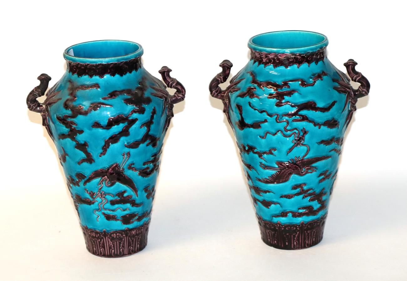 Lot 51 - A pair of twin handled Continental vases decorated with Chinoiserie designs (a.f.)