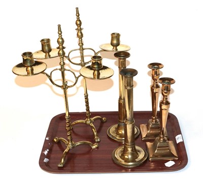 Lot 70 - A pair of adjustable twin-light brass candelabra; together with two pairs of brass candlesticks