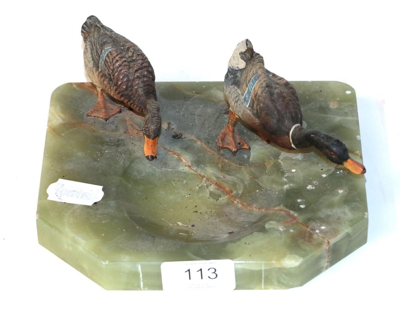 Lot 113 - Cold painted bronze models of two ducks, mounted on an onyx base