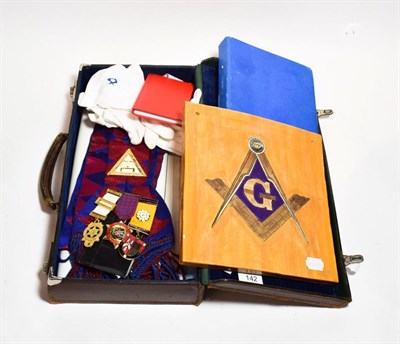 Lot 142 - A leather case, containing Masonic regalia, together with a Masonic tile