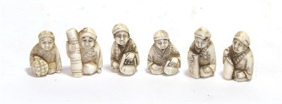 Lot 152 - A set of six Japanese ivory netsukes, Meiji period, each as a seated figure holding various...