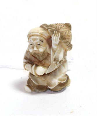 Lot 153 - A Japanese ivory netsuke, Meiji period, as Jurojin carrying a large hat and a peach, signed,...