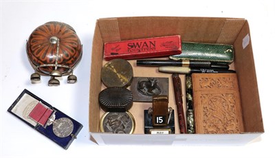 Lot 178 - A box of collectables including various gold nib pens, bronzed desk stand, carved case, King George