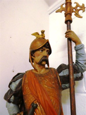 Lot 220 - A painted spelter figure of a Continental soldier with dragon surmounted helmet and halberd, on...