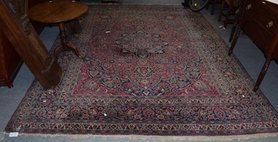 Lot 329 - A Herati rug, the raspberry field with floral motifs, within confirming borders, 365cm by 274cm