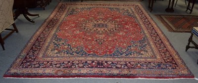 Lot 330 - A large Herati rug, the central floral medallion on a red ground, within spandrels and narrow...