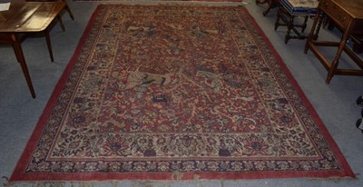 Lot 331 - An Indo-Persian rug, the central field of mounted huntsman, trees, animals and birds, within...