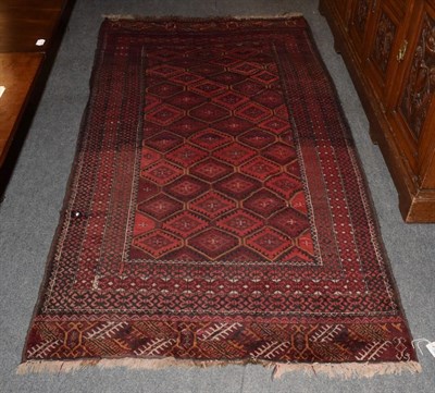 Lot 332 - A Bukhara style rug, the central field of lozenges on a red brick ground, among narrow borders,...