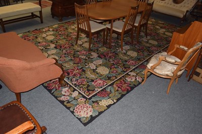 Lot 340 - A woven carpet, the overall designs of blossoms and leaves on a black ground, 440cm by 308cm