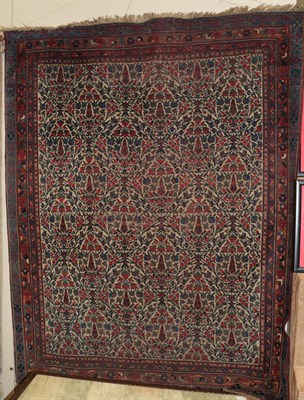 Lot 341 - An Indo-Persian rug, the central field of meandering vines within conforming narrow borders,...