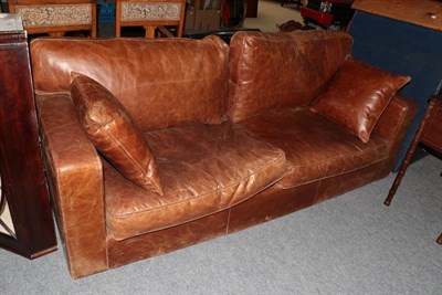 Lot 351 - A brown leather four seater sofa