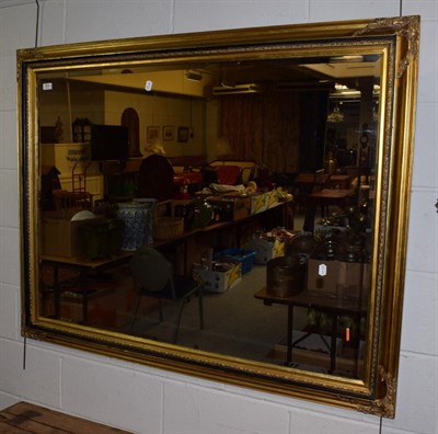 Lot 358 - ^ A reproduction gilt framed over mantel mirror, part ebonised and with bevelled plate