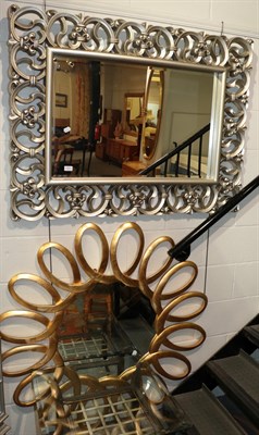 Lot 371 - ^ A reproduction silvered mirror, together with another mirror, gilt framed and in the form of...