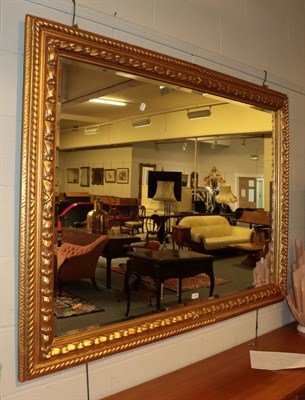 Lot 379 - ^ A rectangular gilt framed hall mirror with conforming bevelled plate and leaf and rope carved...