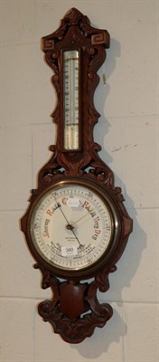 Lot 380 - A late Victorian carved oak aneroid barometer, pottery dial signed Geo F. Brown & Co., Carlisle