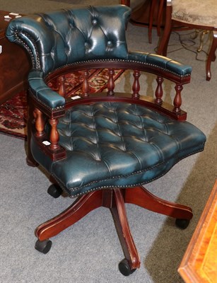 Lot 383 - A reproduction blue buttoned leather swivelling office chair