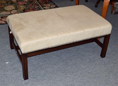 Lot 386 - A modern cream upholstered oversized foot stool, on mahogany frame with twin supporting stretchers